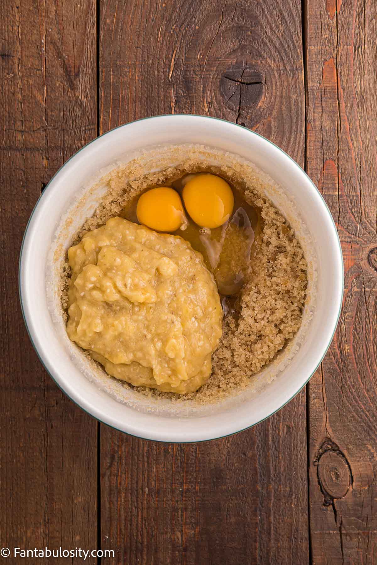 Eggs and banana mixture added to mixing bowl.