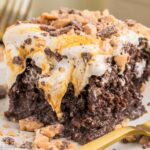 Slice of better than anything cake, showing the toffee and caramel on top of chocolate cake.