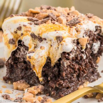 Slice of better than anything cake, showing the toffee and caramel on top of chocolate cake.