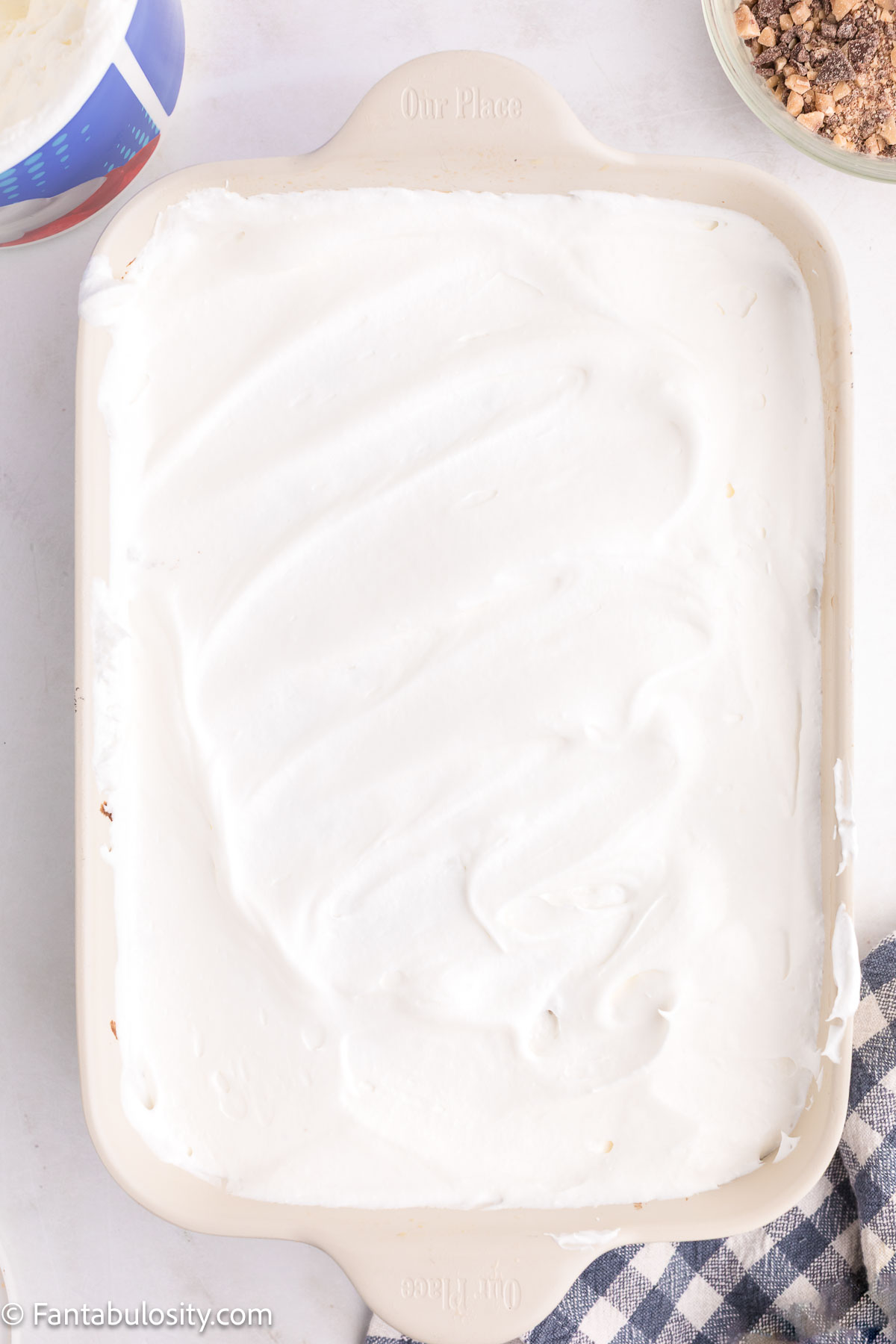 Cool Whip spread over the top of Better Than Anything Cake.