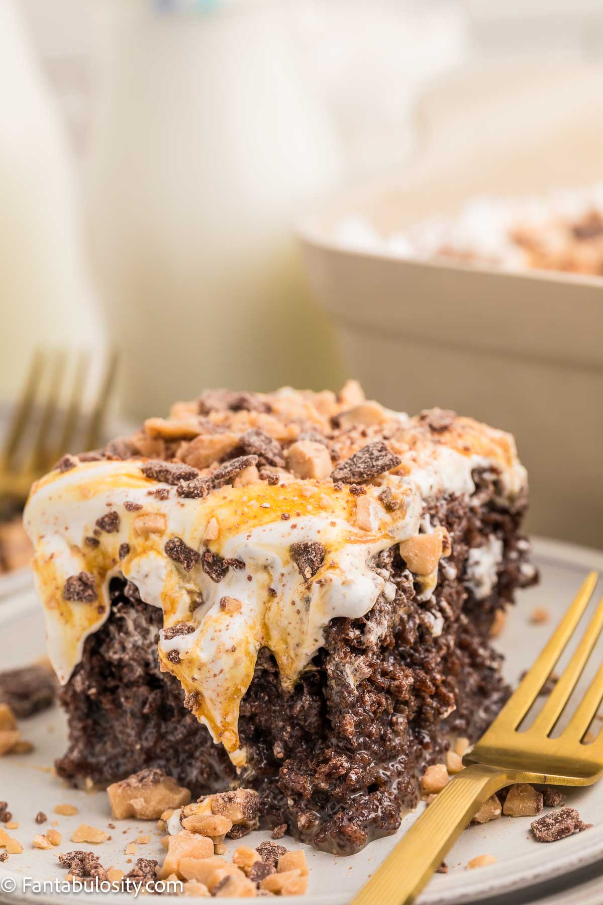 A slice of better than anything cake on a plate, with a fork.