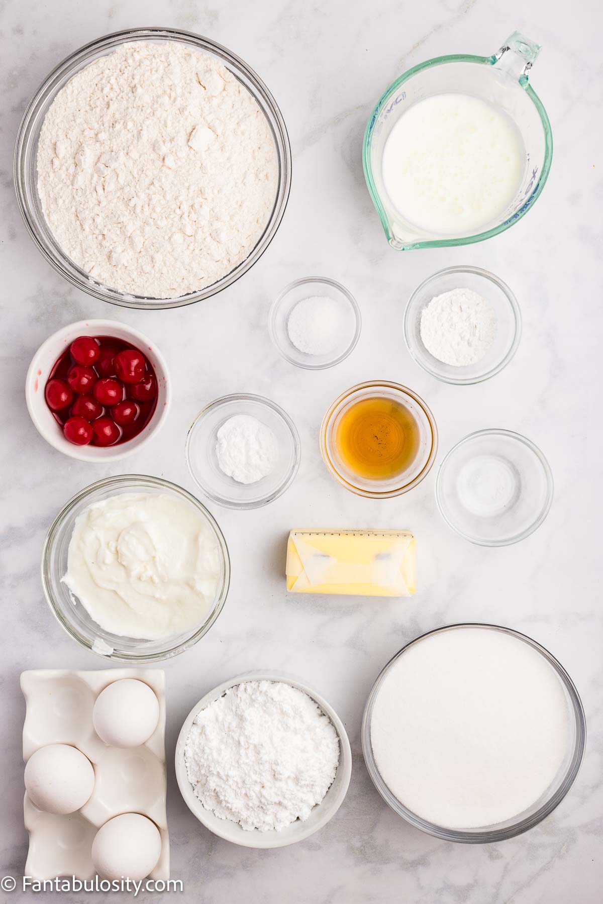 Ingredients to make cherry sheet cake, sitting on table.