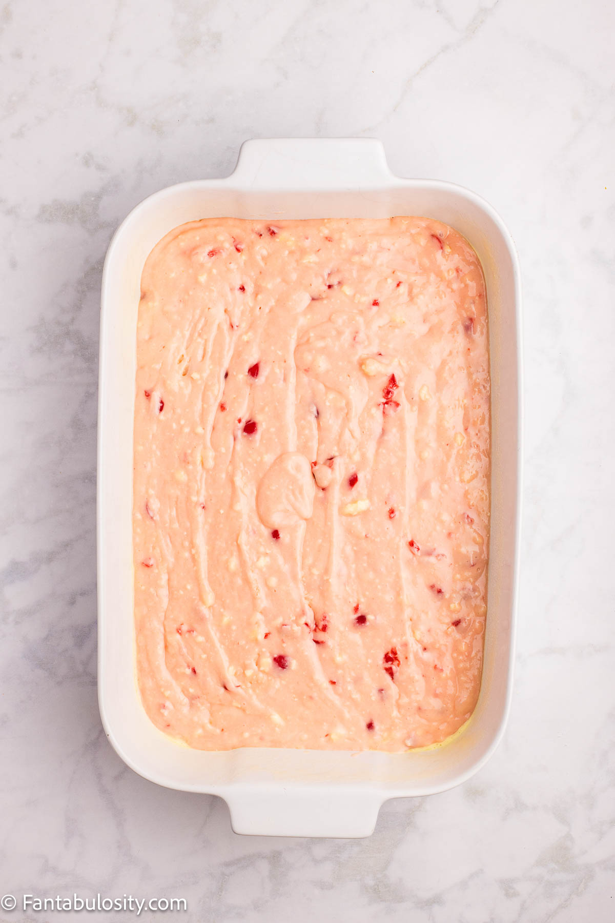 Cherry cake batter poured in to 9x13 baking dish.