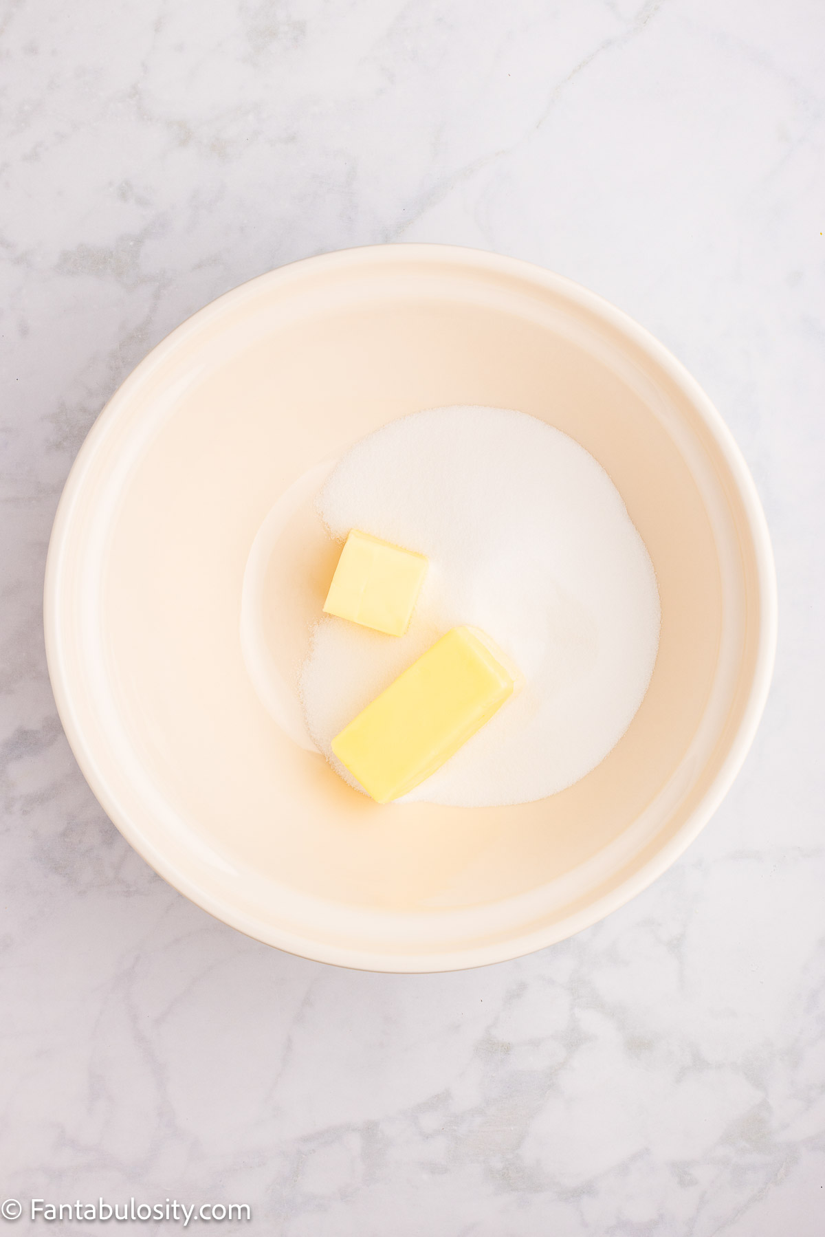 Sugar and butter in mixing bowl.
