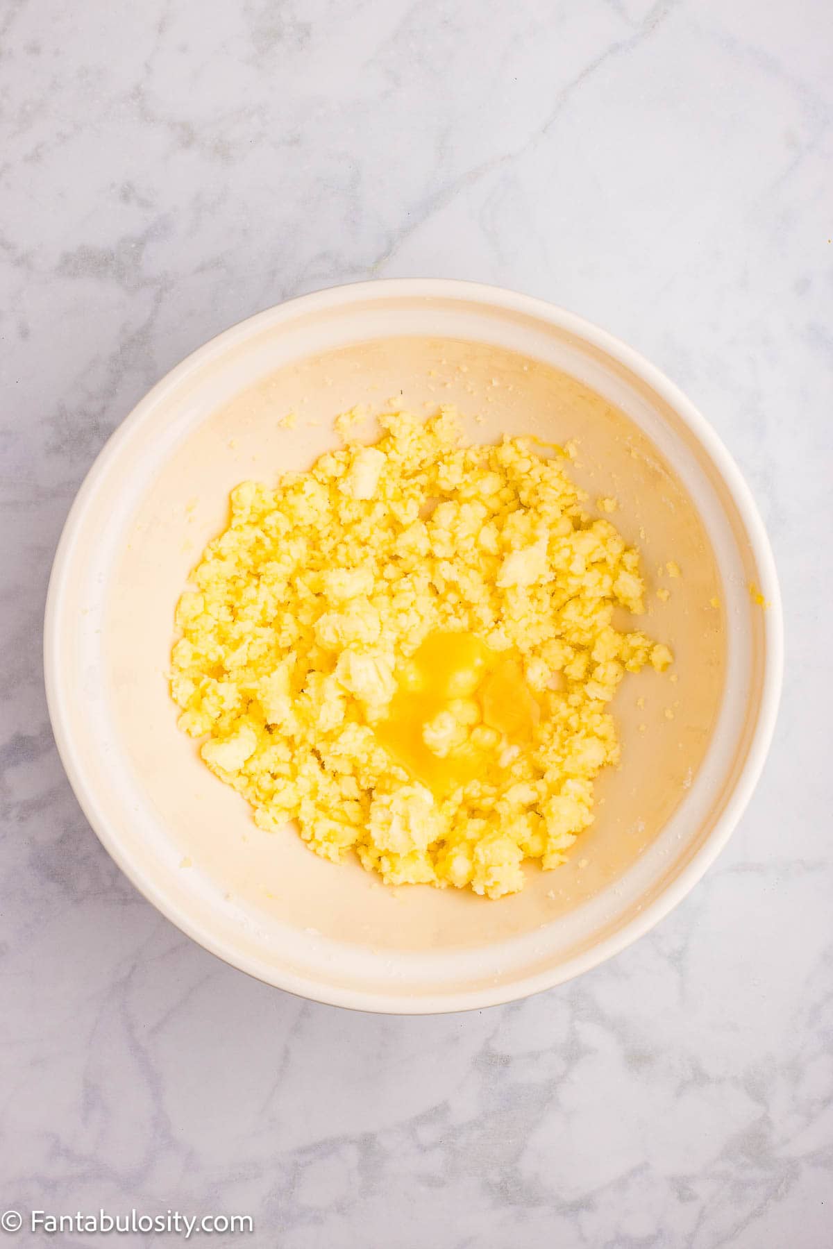 Egg added to sugar and butter in mixing bowl.
