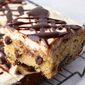 Slice of chocolate chip cake made in a 9x13 pan, with brown sugar buttercream frosting.