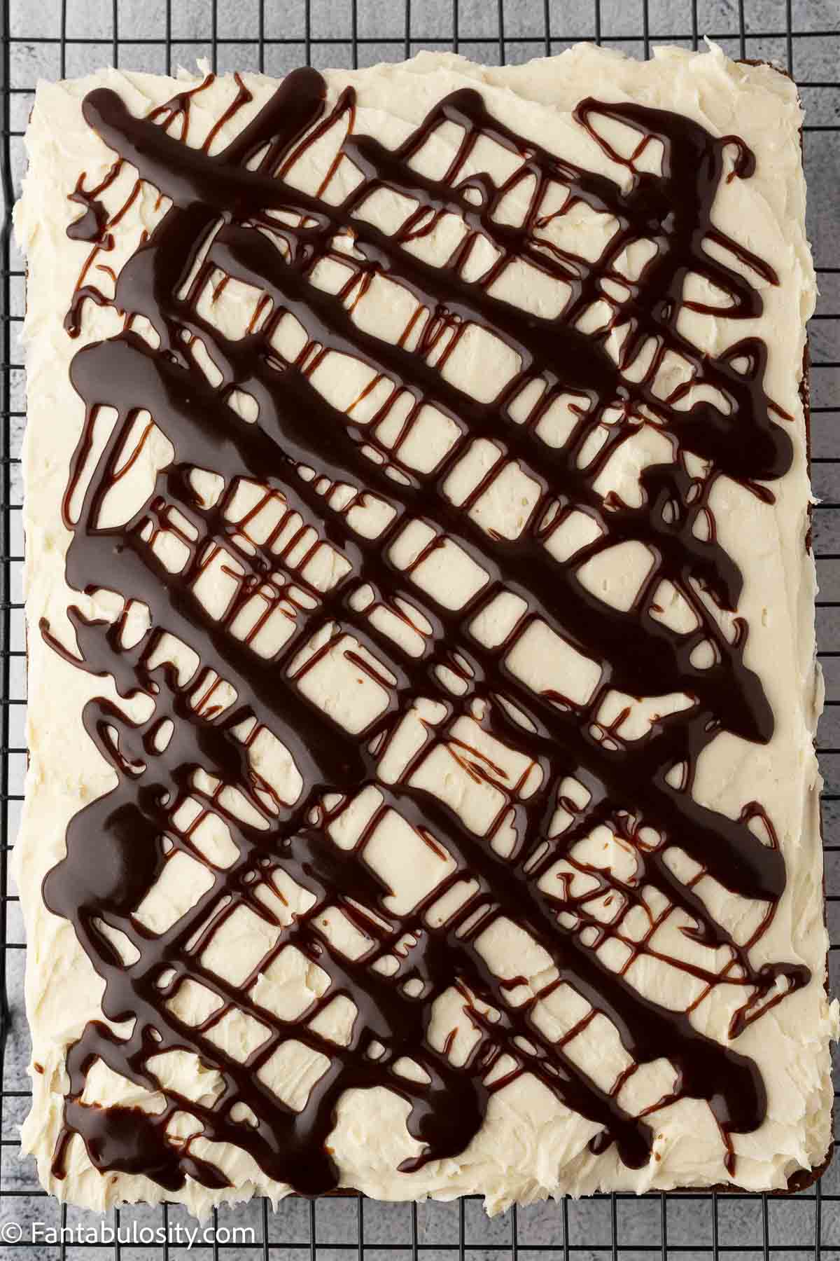 Chocolate swirl on top of chocolate chip cake with brown sugar buttercream frosting.