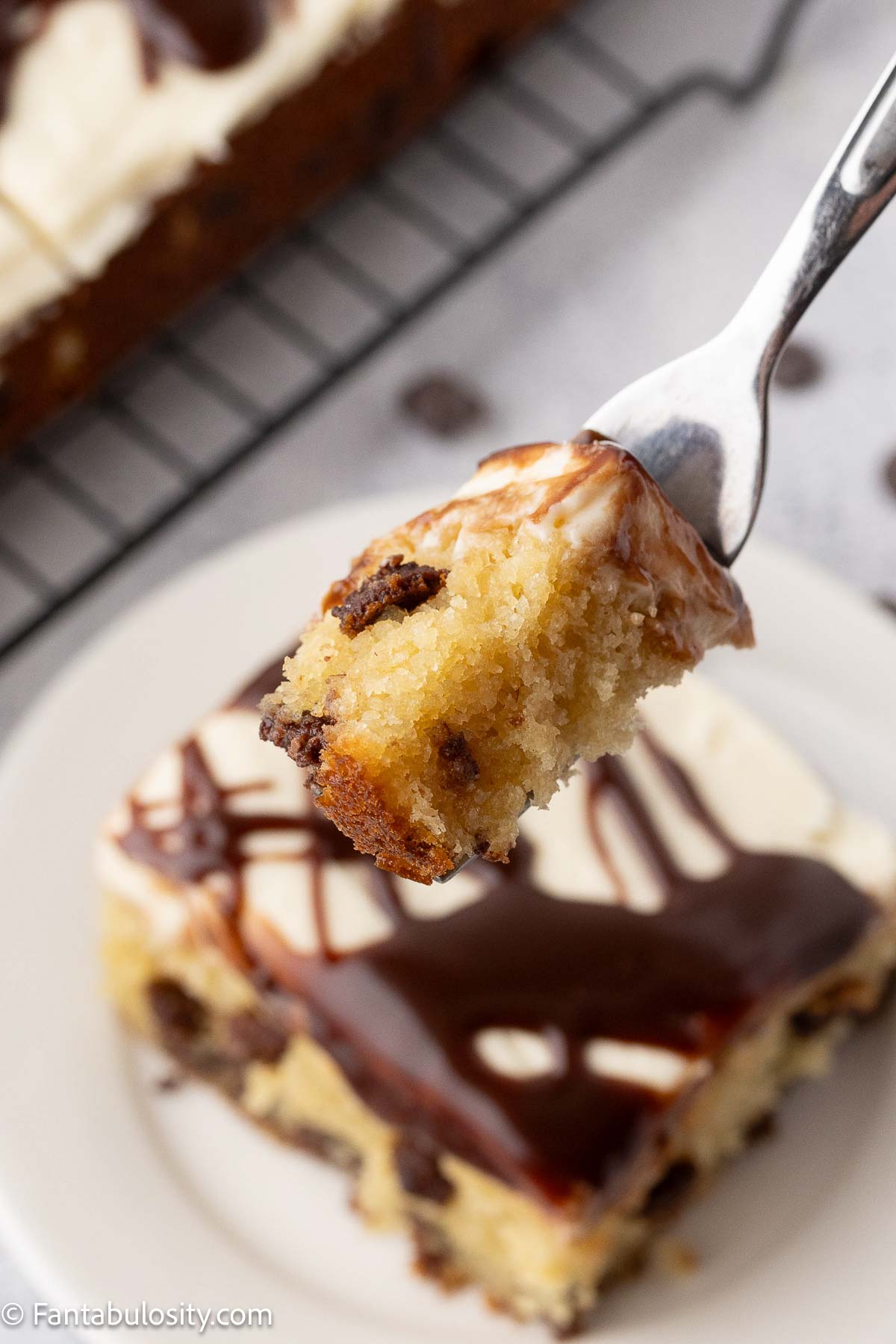A bite of chocolate chip cake on a fork.