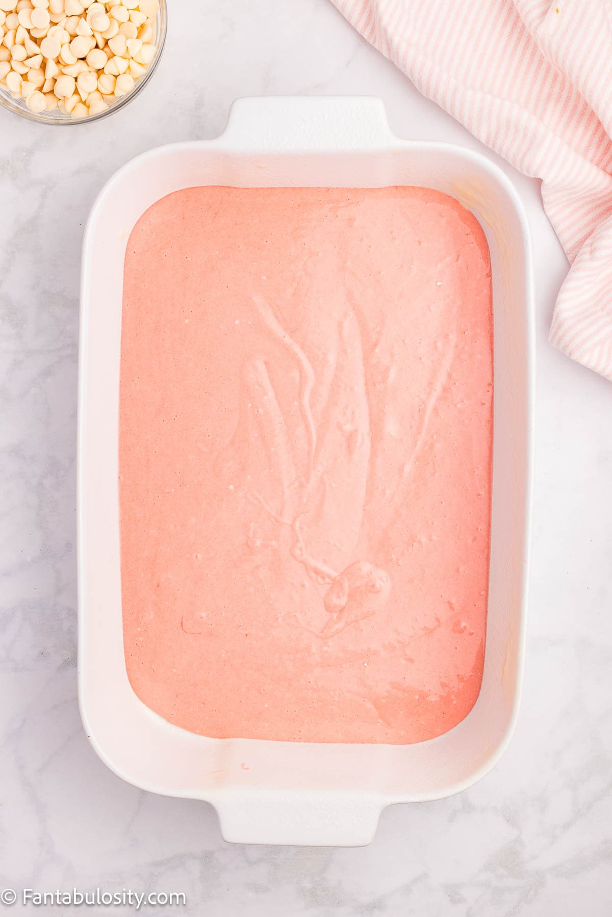 Strawberry cake batter poured in to 9x13 baking dish.