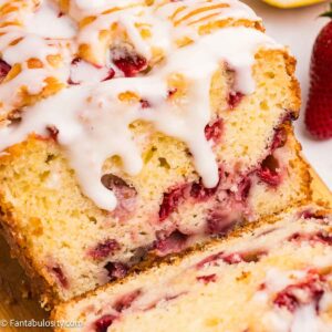 Sliced strawberry lemonade bread, with a glaze dripping over the top.