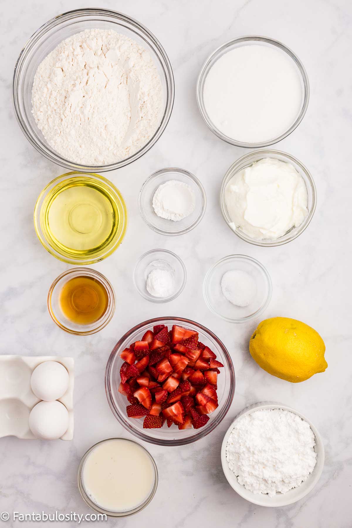 Ingredients on table to make strawberry lemonade bread.