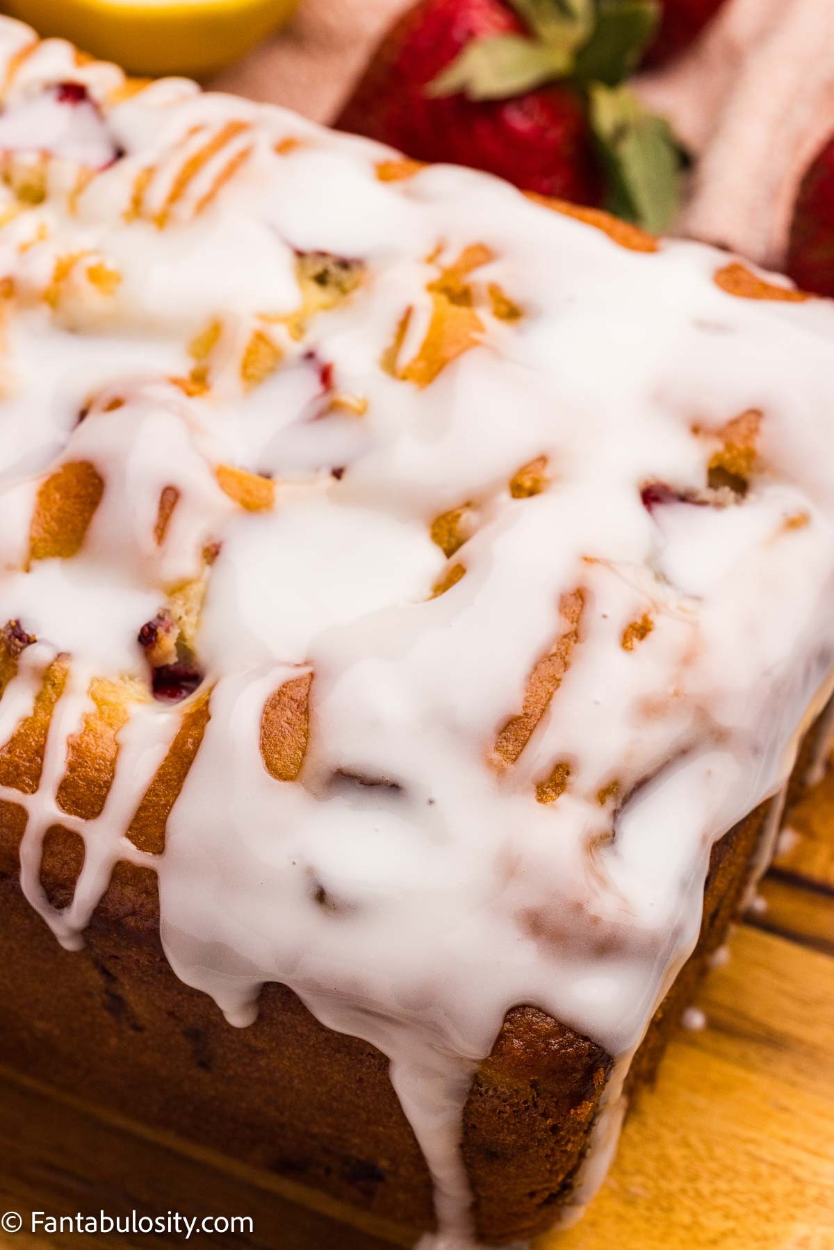 Lemon glaze poured on top of strawberry bread.