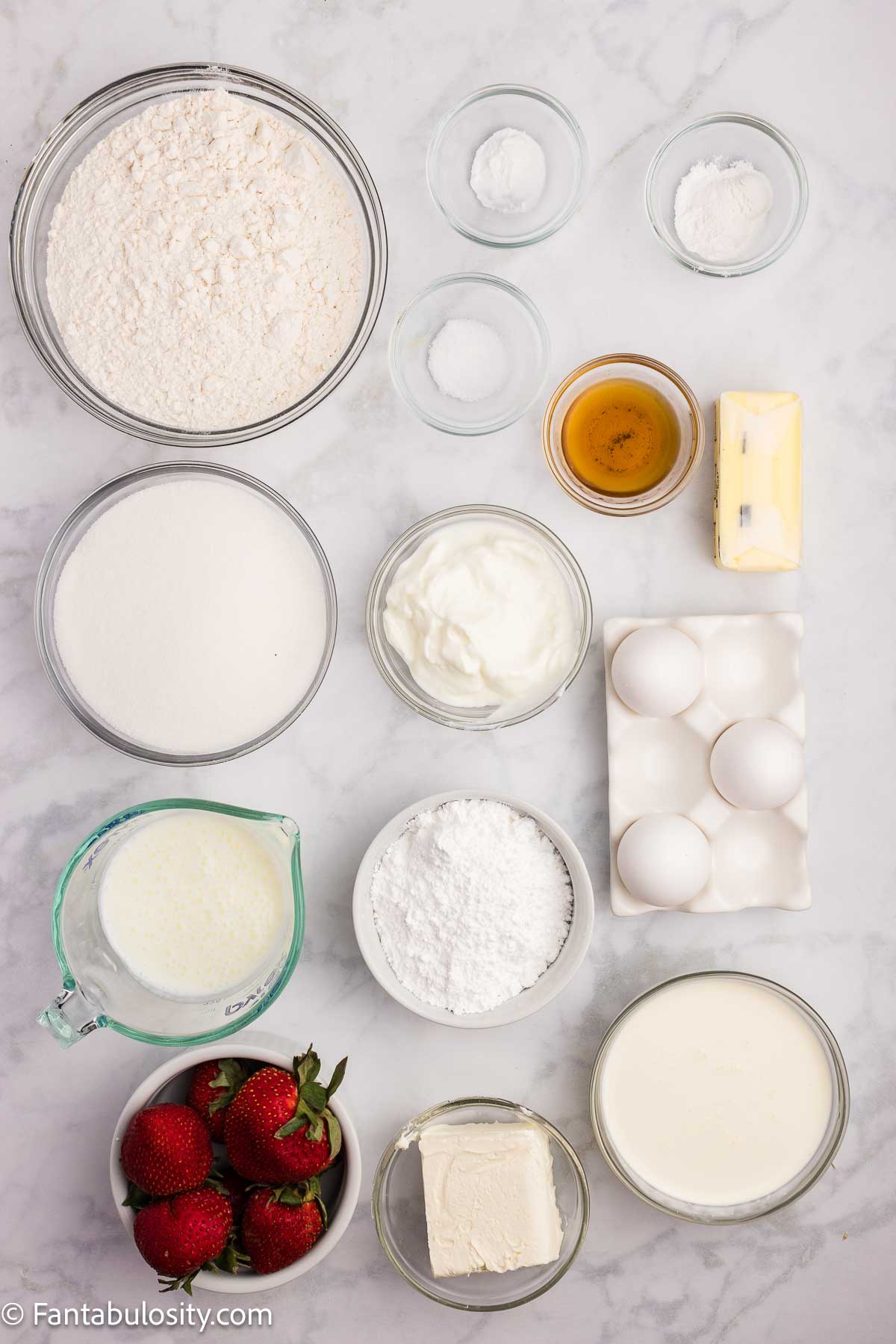 Ingredients on kitchen counter to make strawberry shortcake sheet cake.