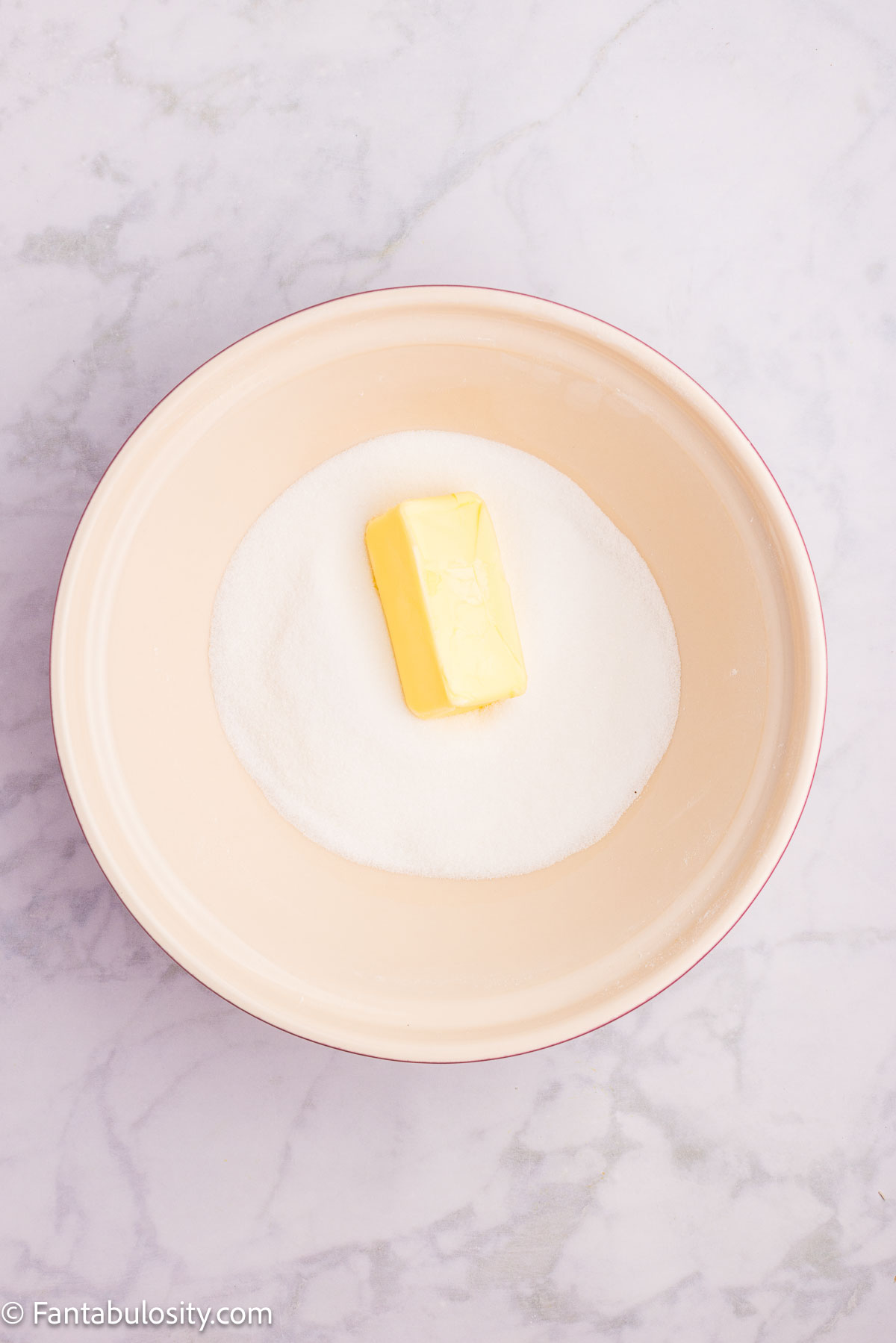 Butter and sugar in mixing bowl.