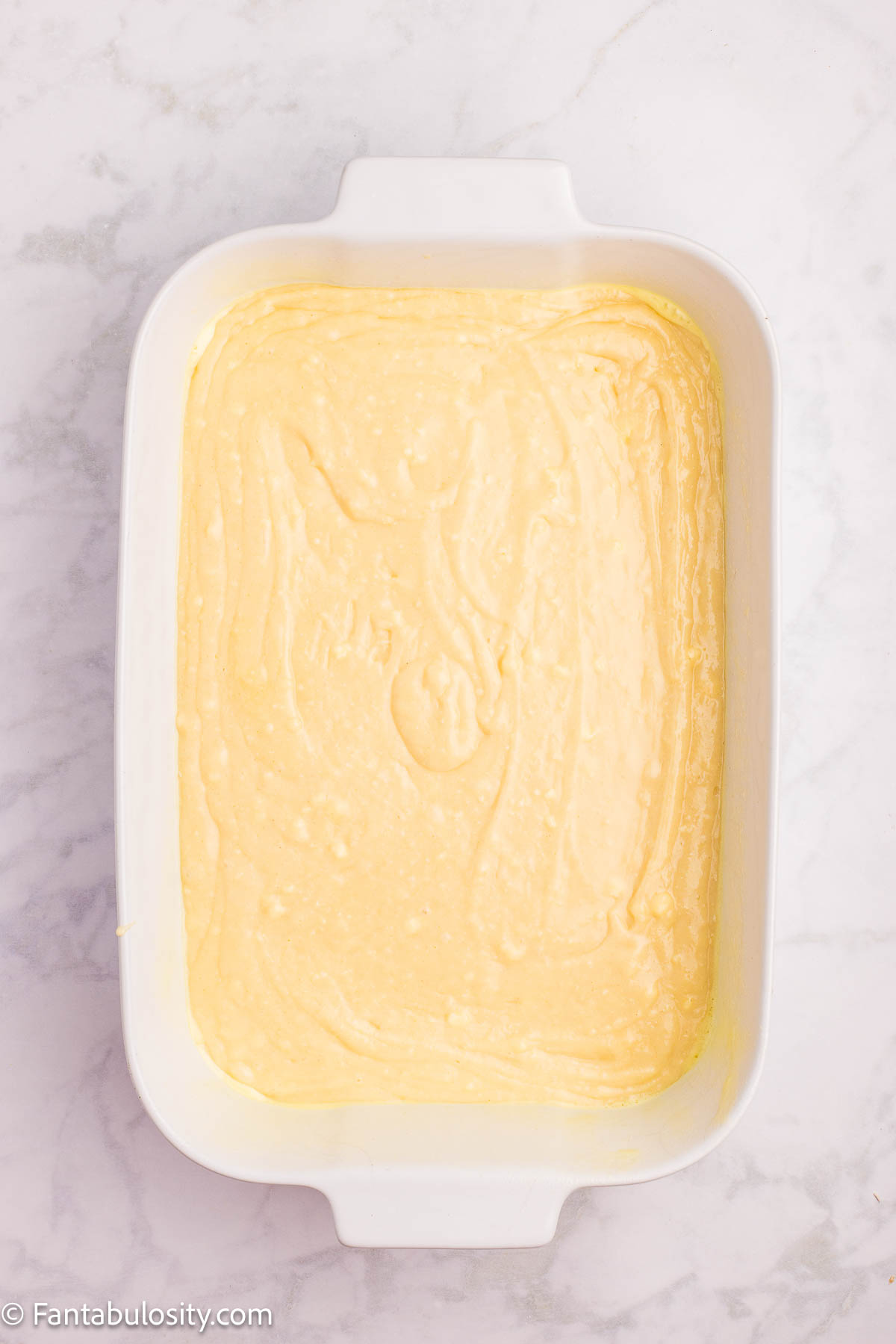 Strawberry shortcake sheet cake batter in 9x13 baking dish.