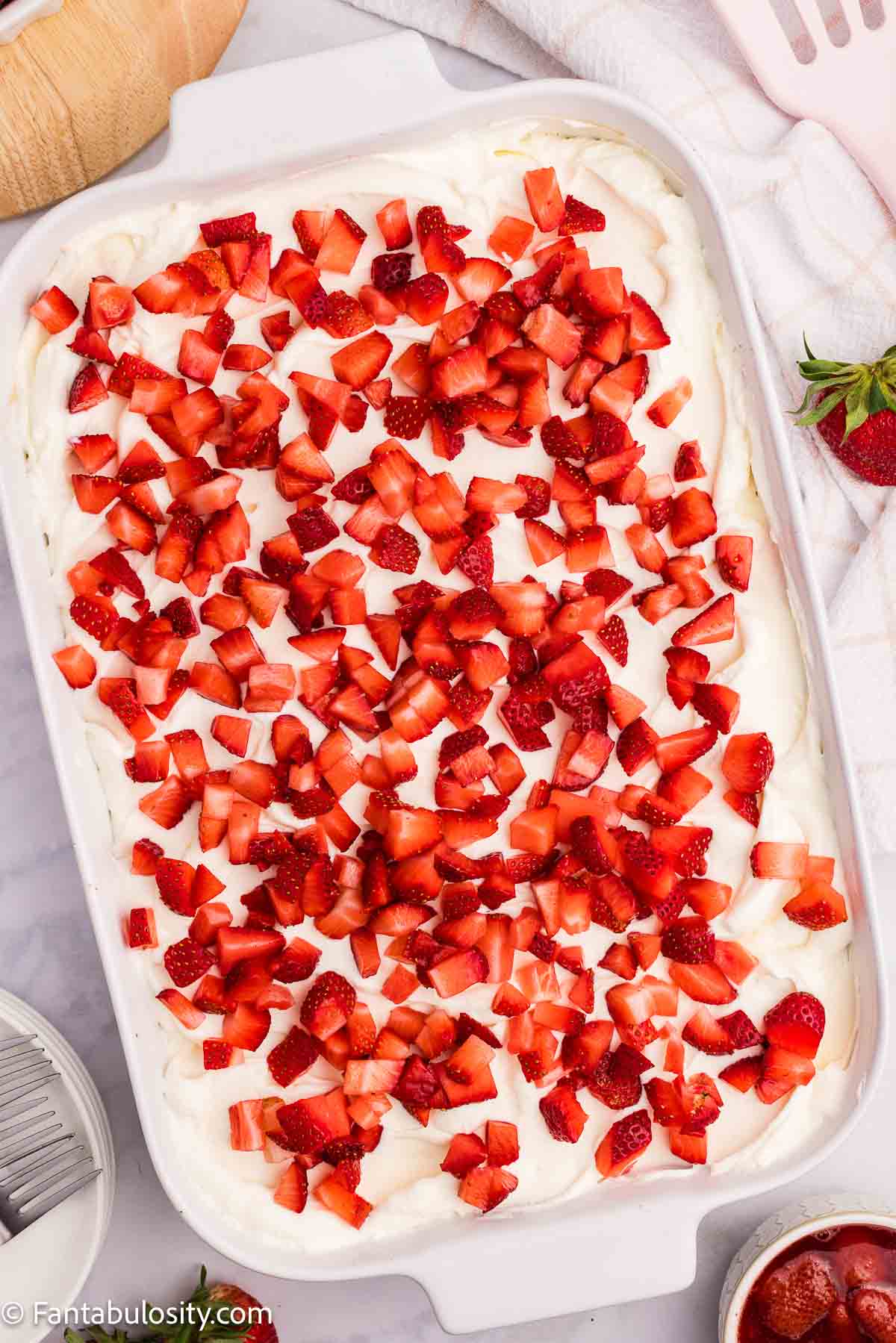 Strawberry shortcake topped with diced strawberries.