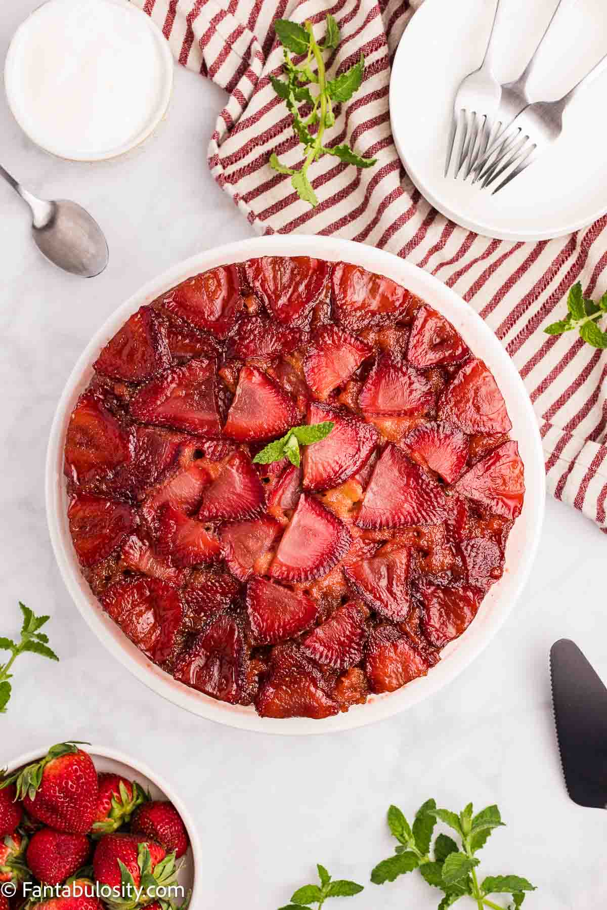Baked strawberry upside down cake on cake stand.