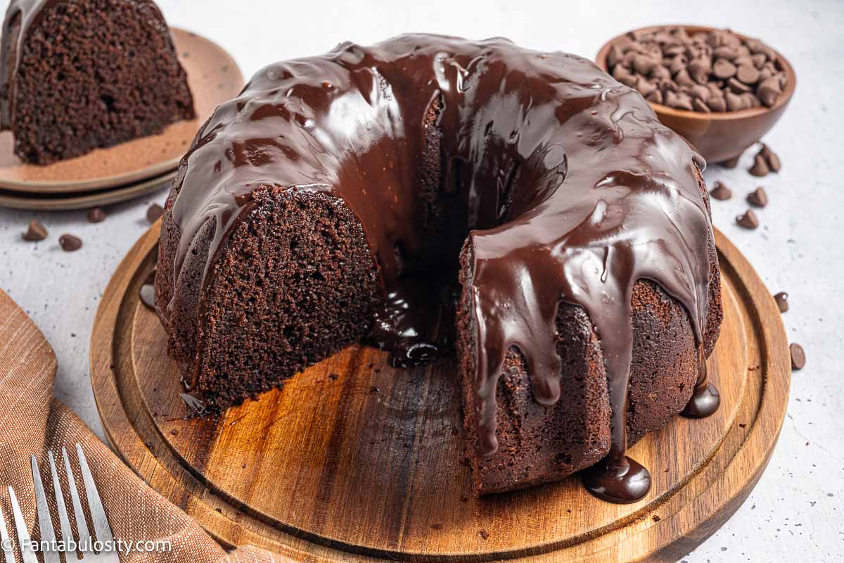 Chocolate brownie cake sliced on wooden cake stand.