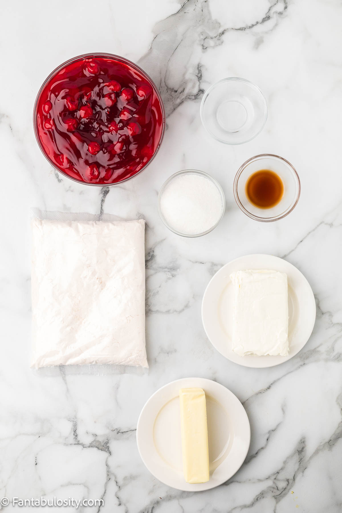 Ingredients for cherry cheesecake dump cake sitting on kitchen counter.