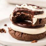 Hostess Cupcake cookies stacked on top of one another and a bite taken out.