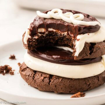 Hostess Cupcake cookies stacked on top of one another and a bite taken out.