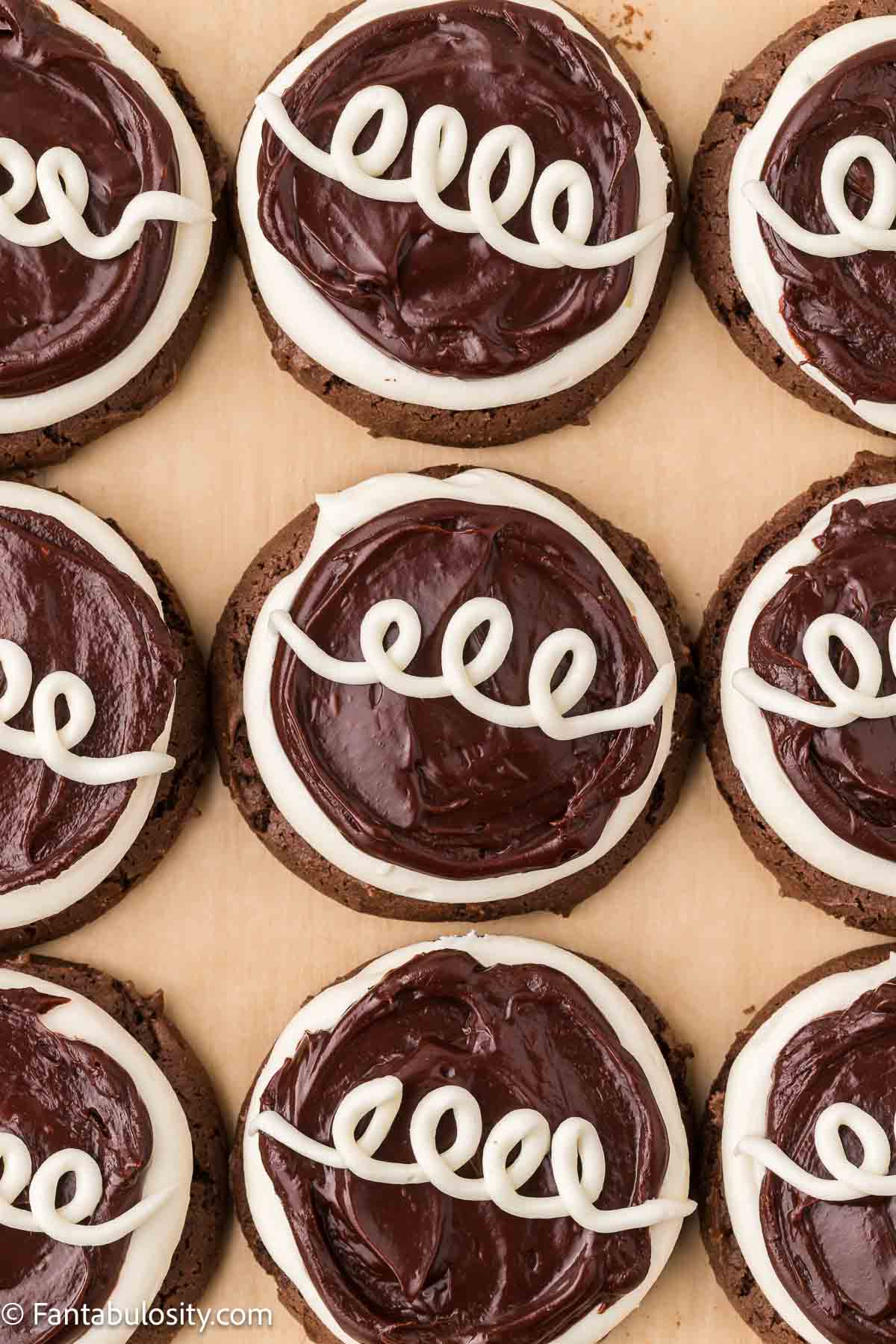 White icing piped on to Hostess Cupcake cookies.