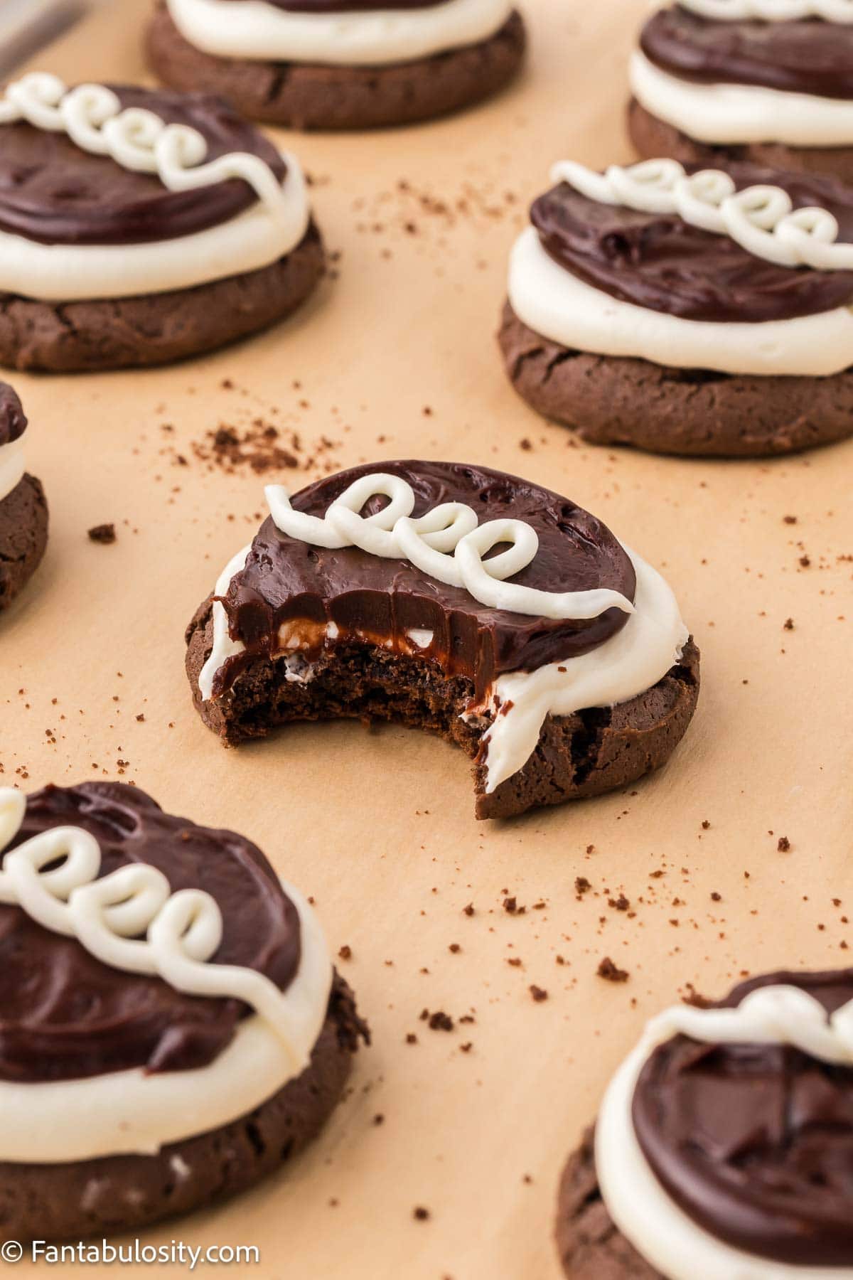 Hostess Cupcake cookies on baking sheet, with bite taken out of cookie.