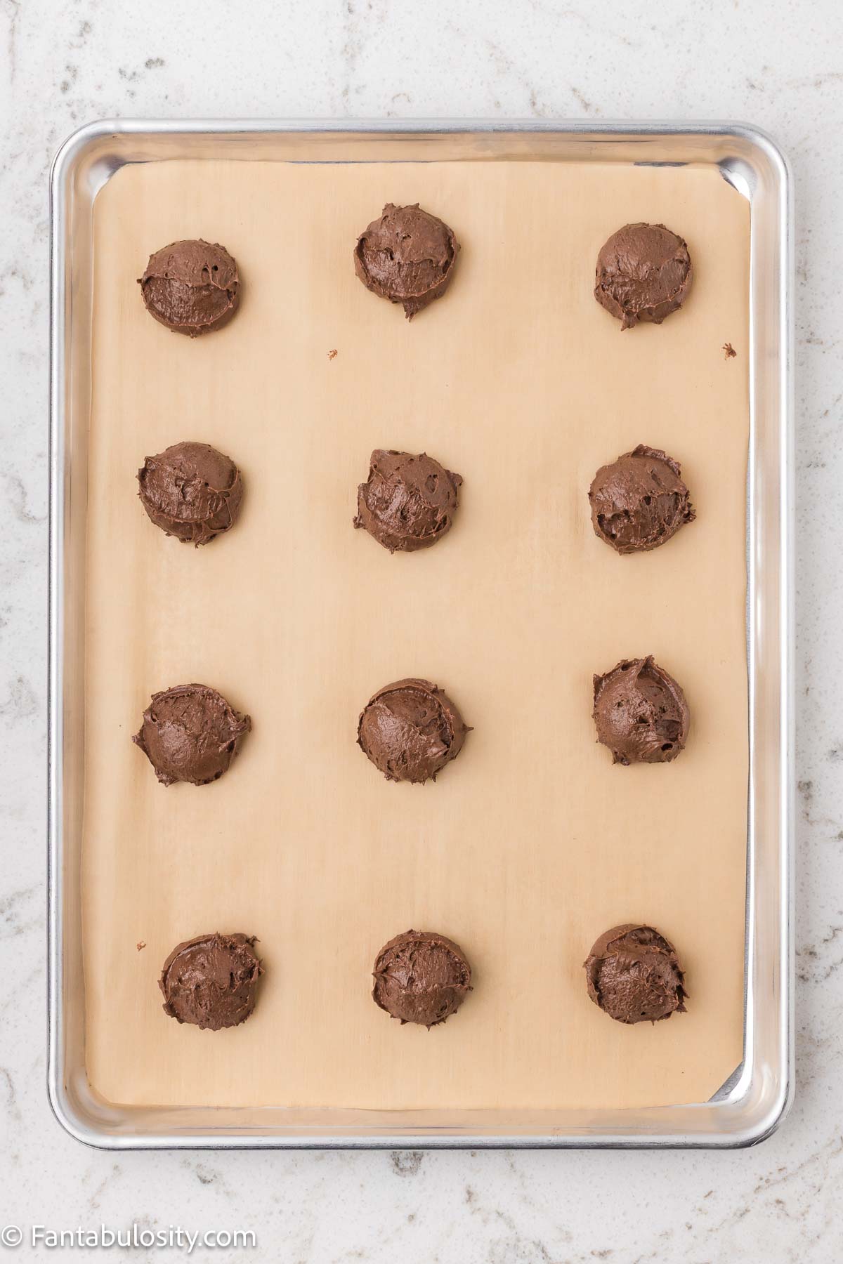 Cookie dough scooped out on to baking sheet.