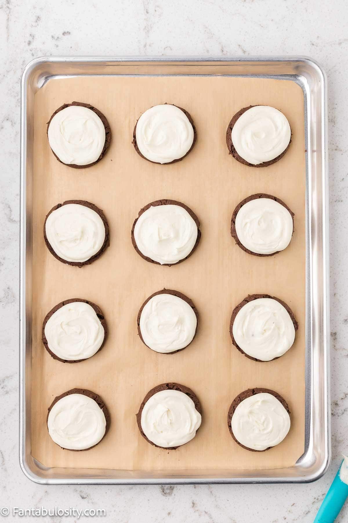 Marshmallow filling piped on to chocolate cookies.