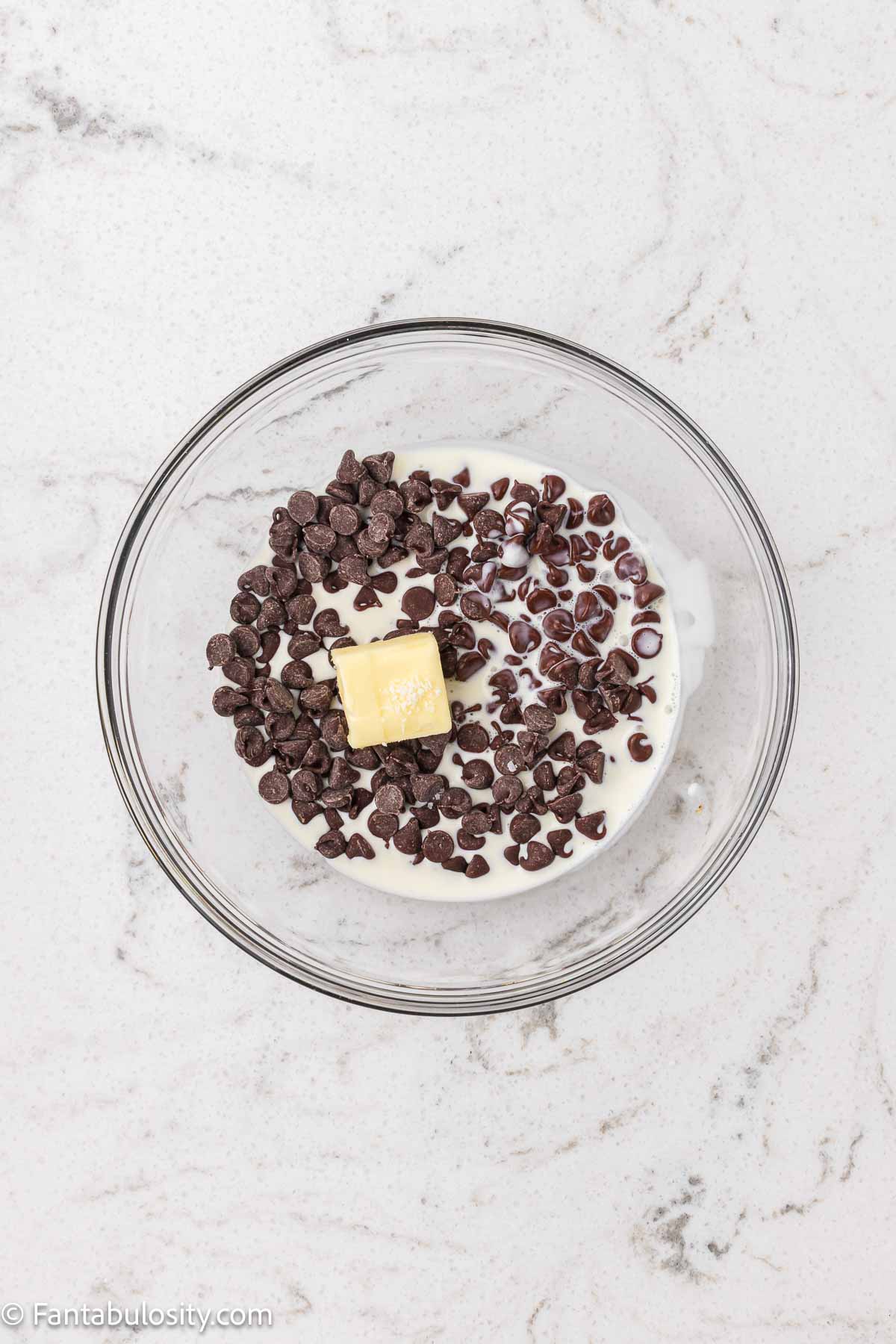 Chocolate chips, butter and heavy cream in a mixing bowl for ganache for Hostess Cupcake Cookies.