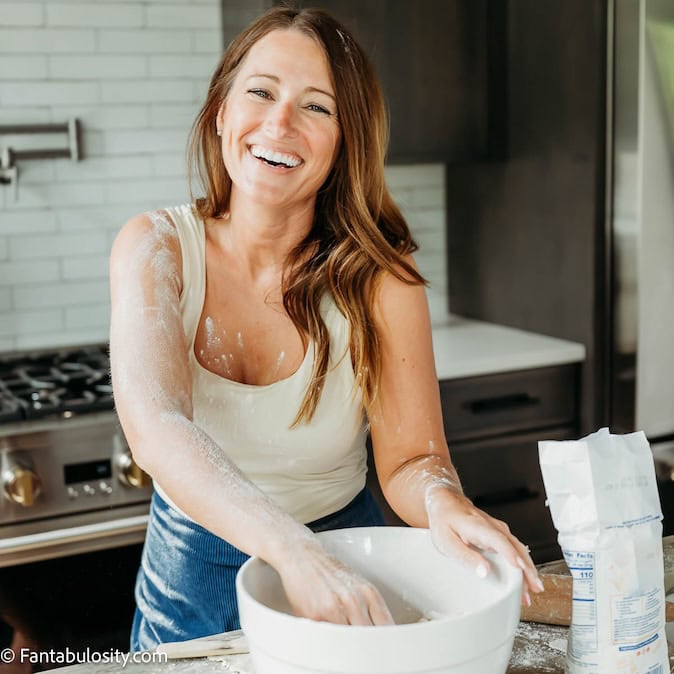 Jessica Burgess standing in kitchen making a recipe.