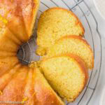 Orange juice cake sliced on a cake stand.