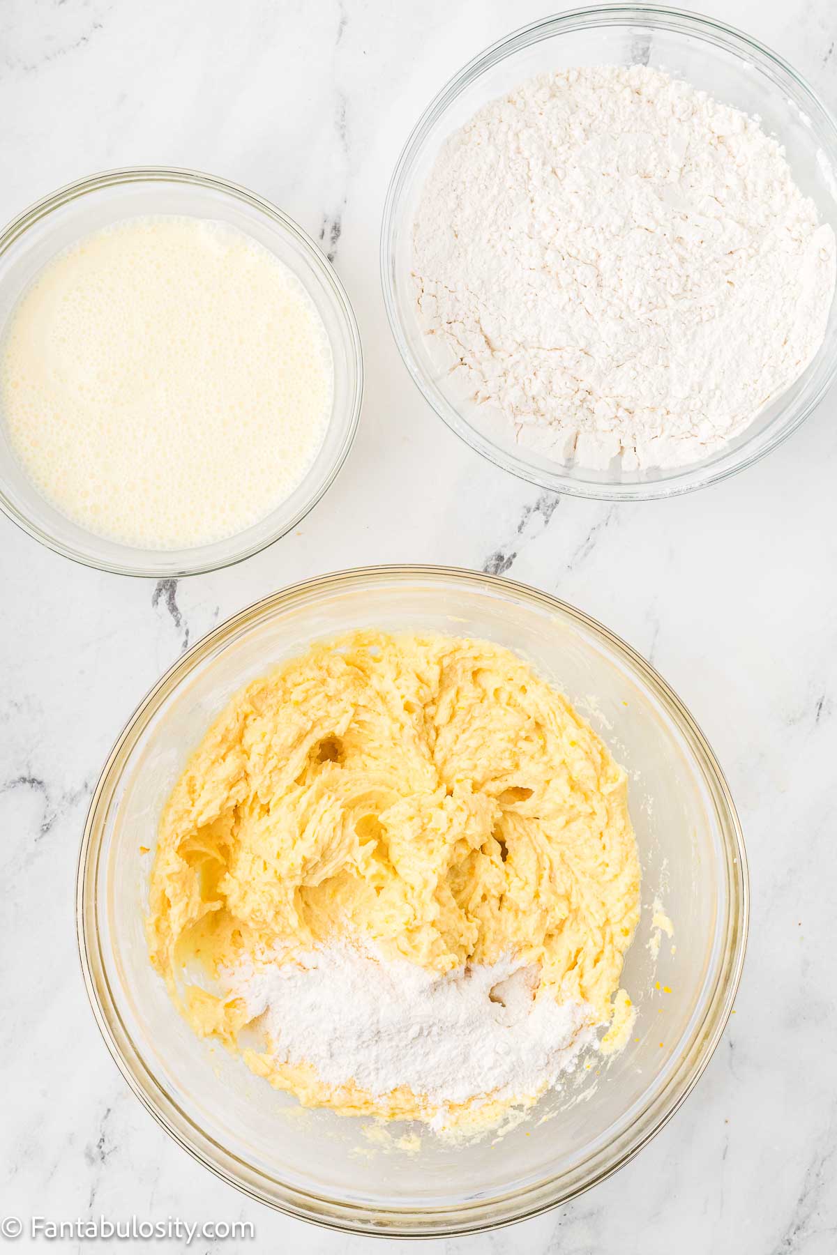Flour being added to cake batter.