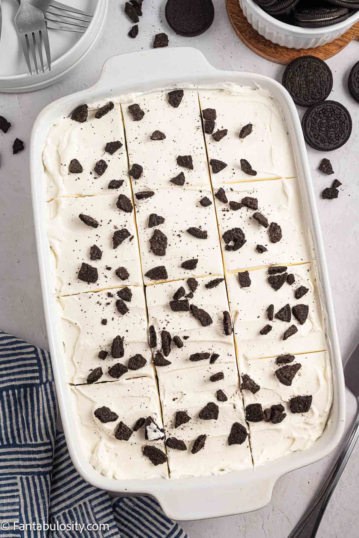 Chopped Oreos sprinkled on top of Oreo Tres Leches cake.