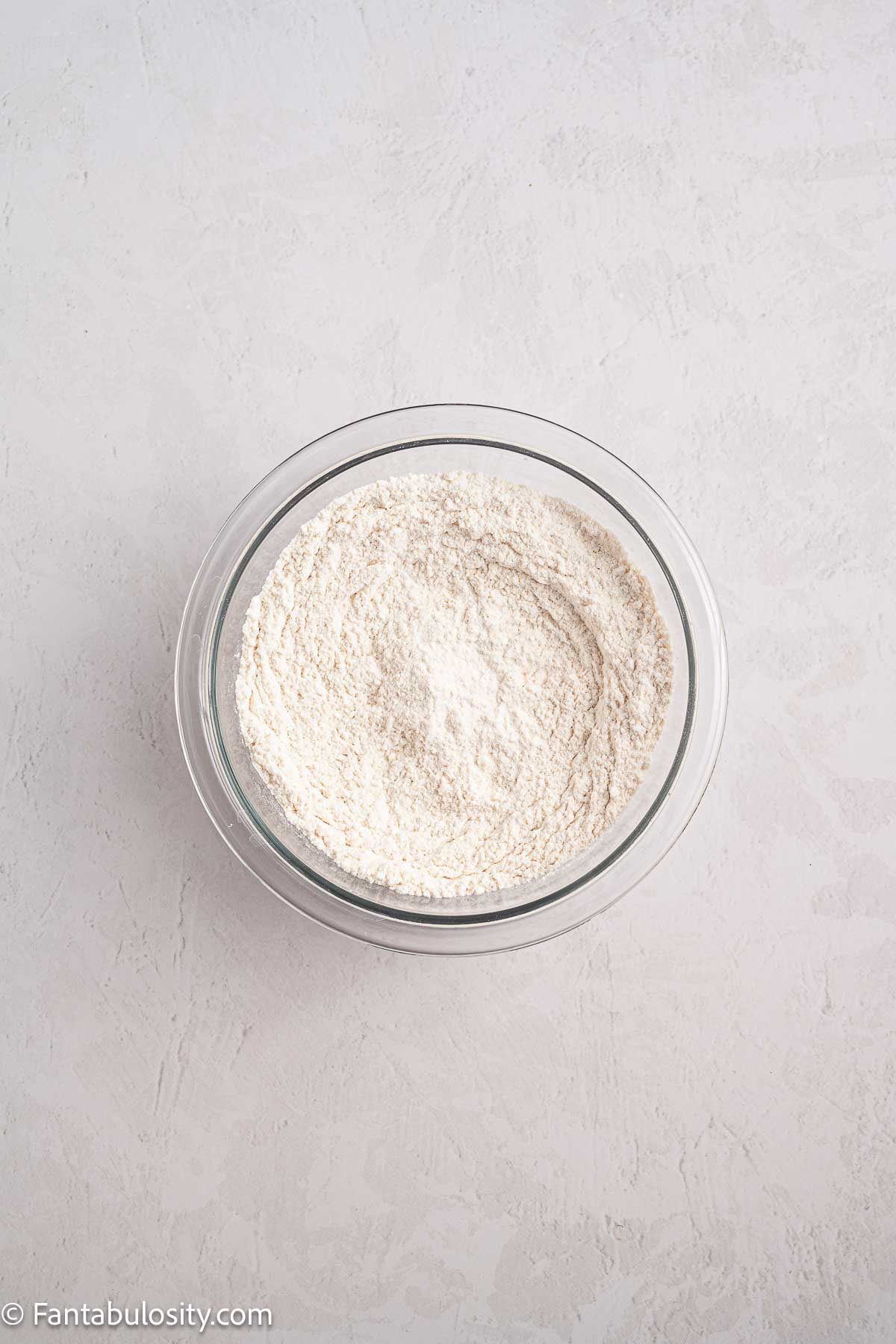 Flour and dry ingredients mixed in mixing bowl.