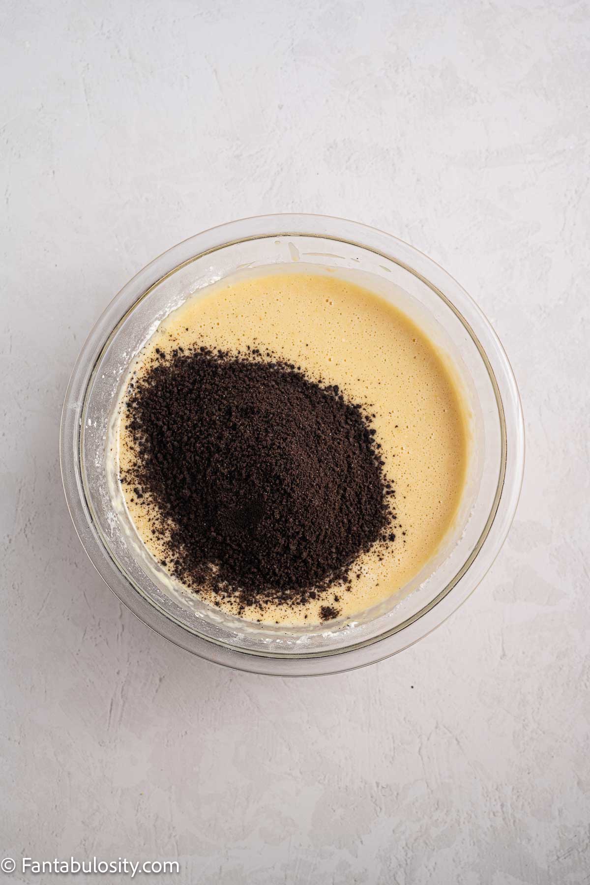 Oil, sugar and crushed Oreos in mixing bowl.