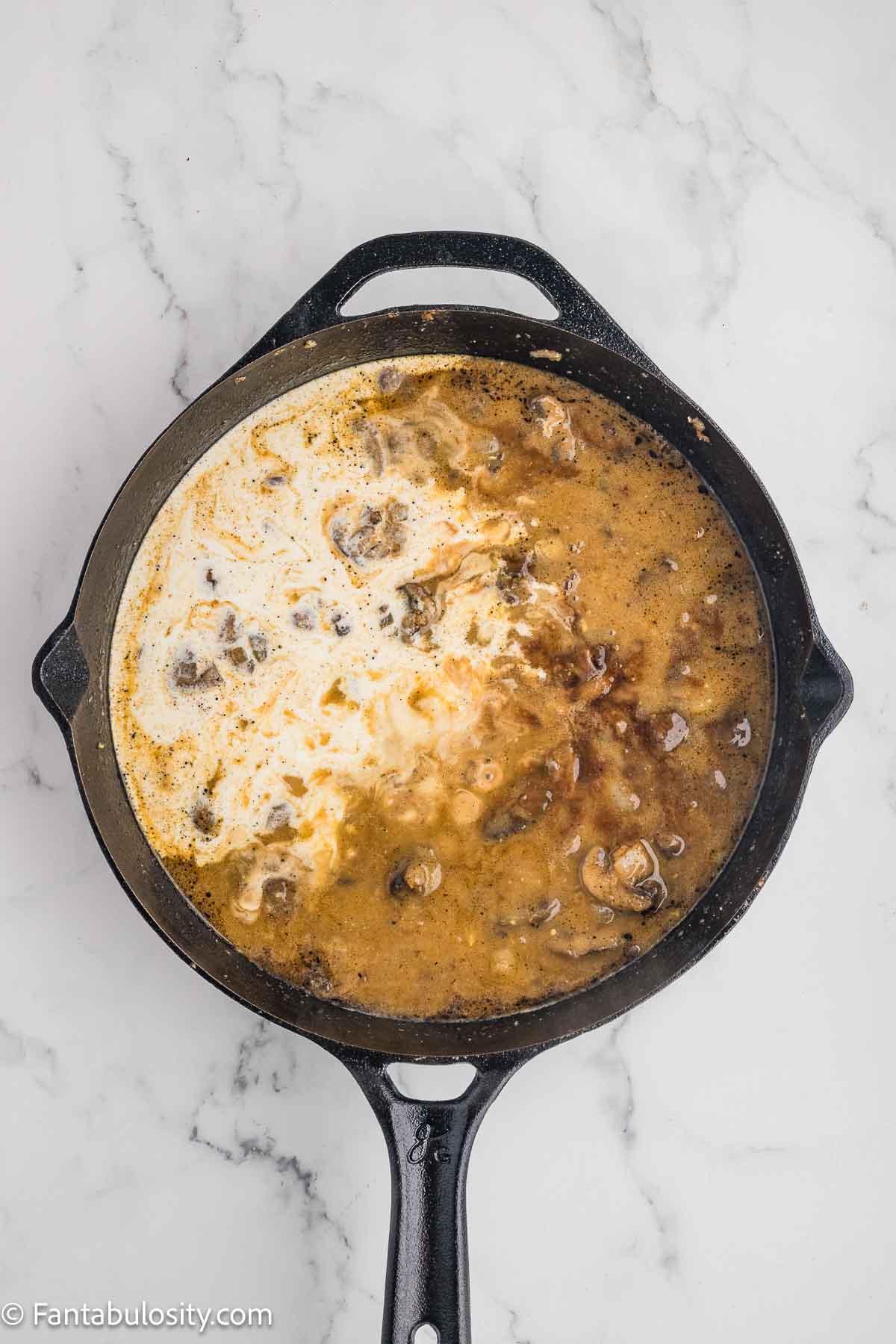 Broth and sauces added to skillet.