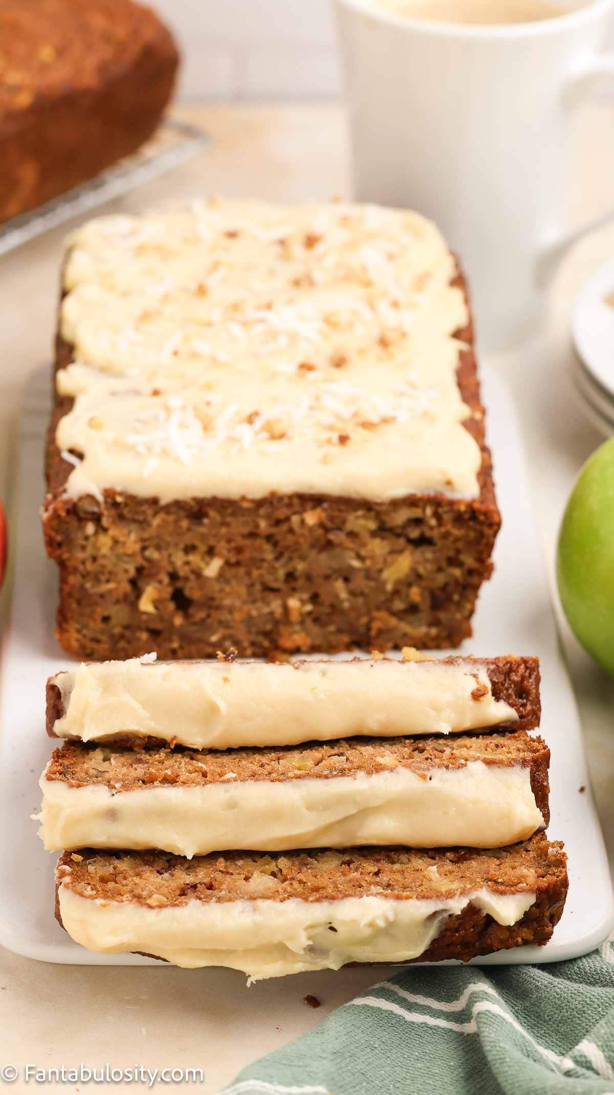 Apple bread with maple glaze, sliced on platter.