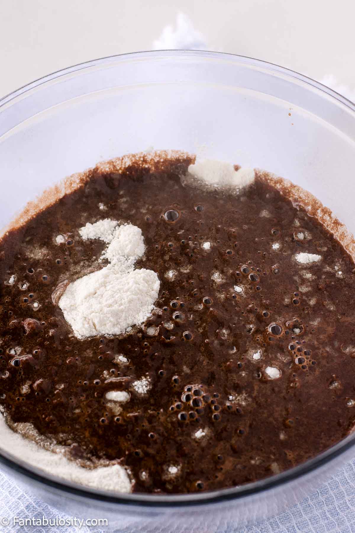 Hot chocolate mixture poured in to dry ingredients.