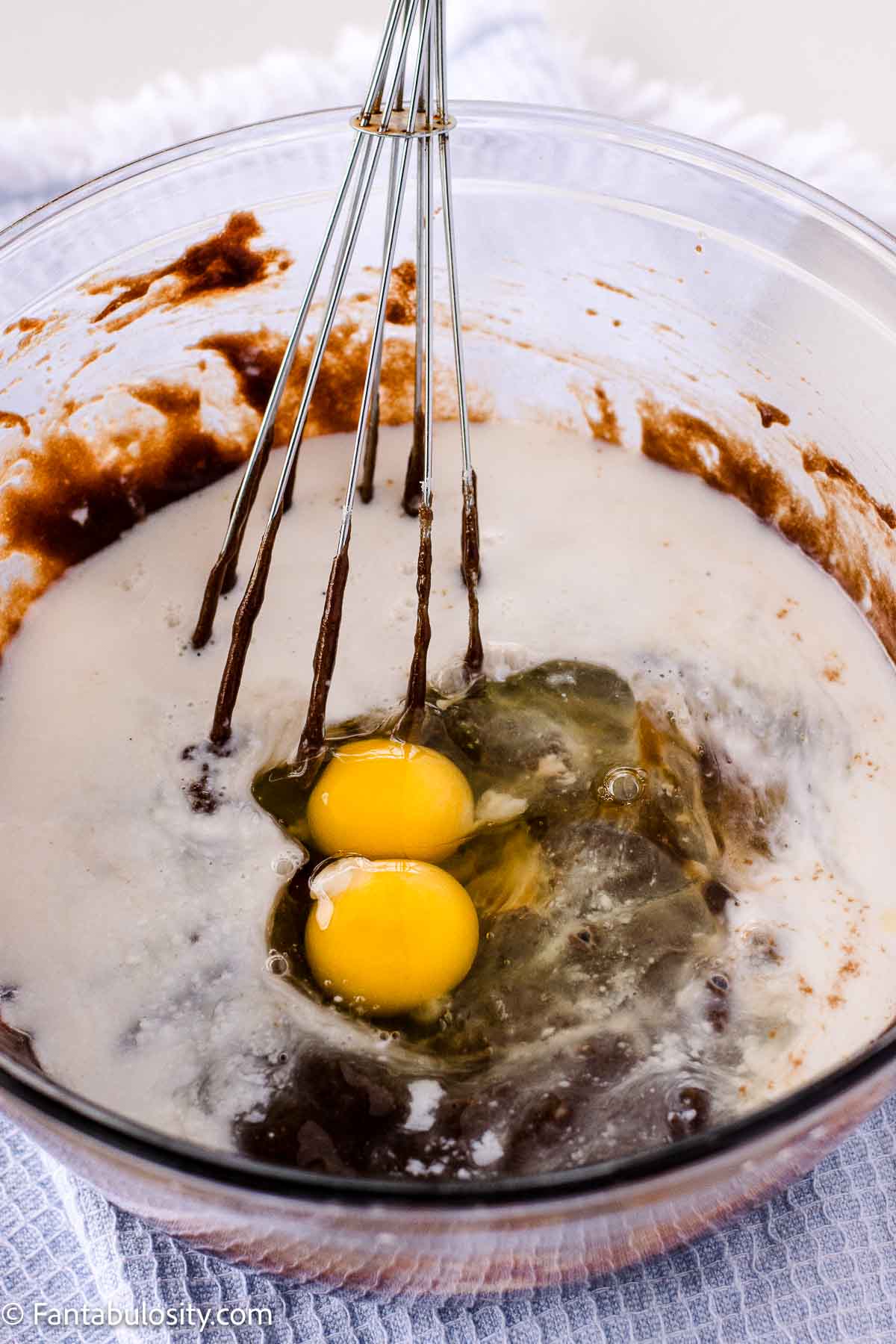 Eggs, buttermilk and oil added to chocolate mixture in mixing bowl.