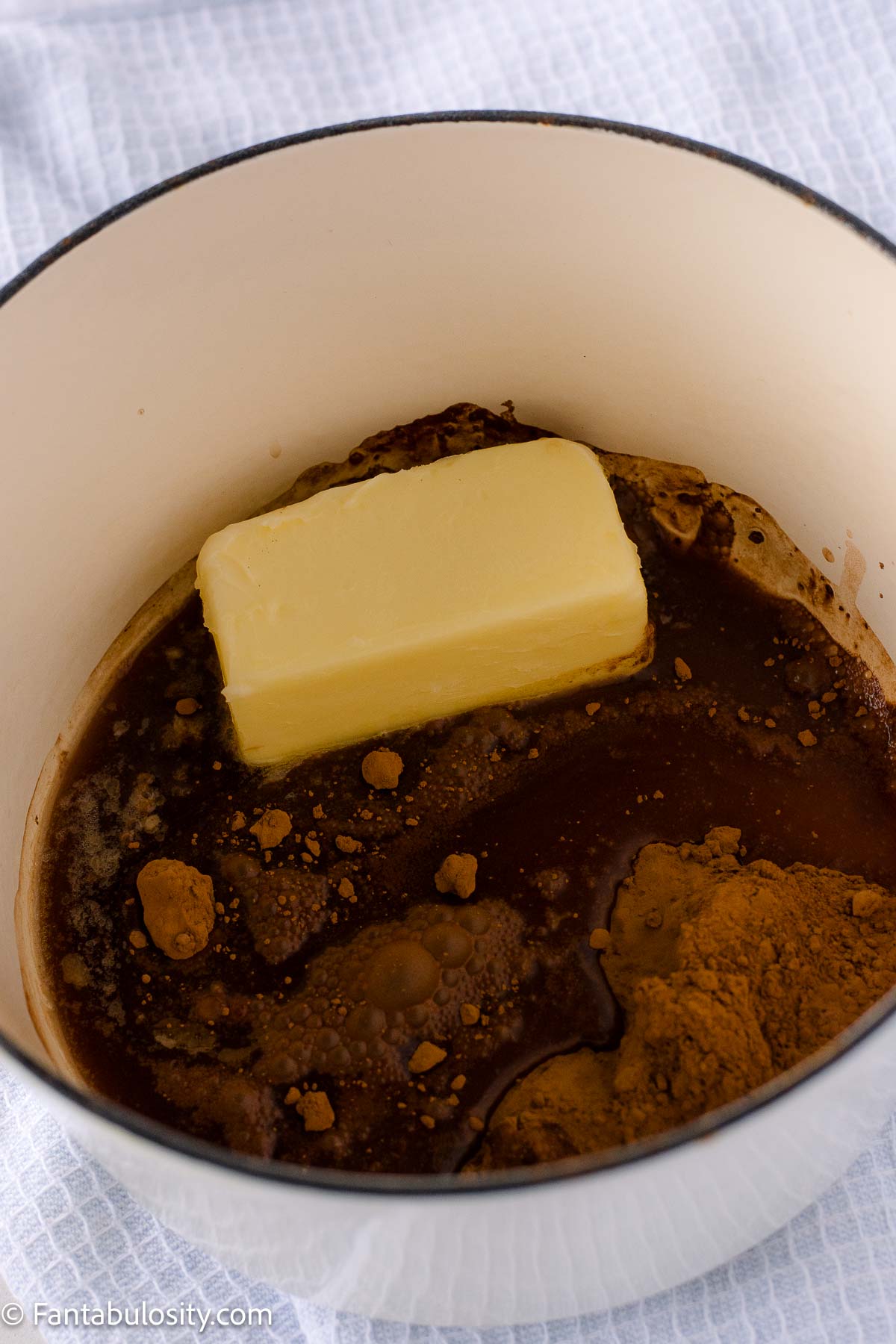 Cocoa butter and Coca Cola in a sauce pan.
