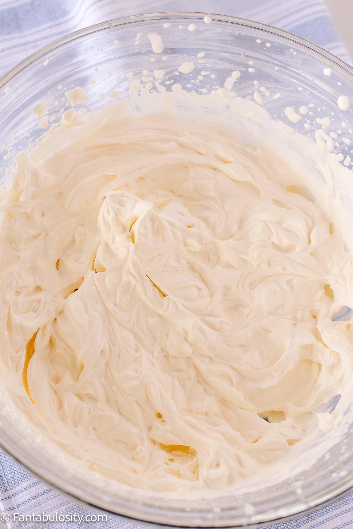 Homemade whipped cream in a mixing bowl.