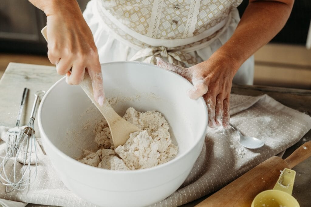 Woman creating chicken and dumplings dough.