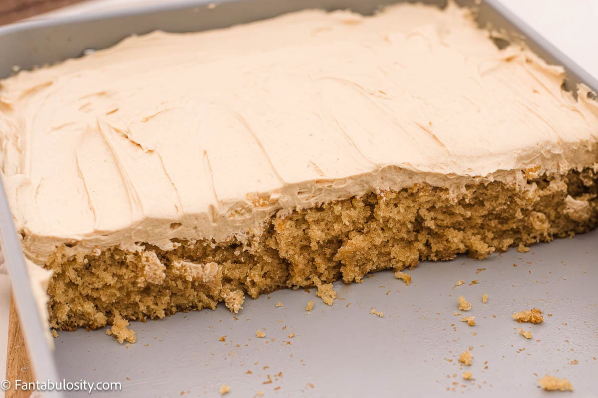 Half of a peanut butter sheet cake in a 9x13 baking pan.
