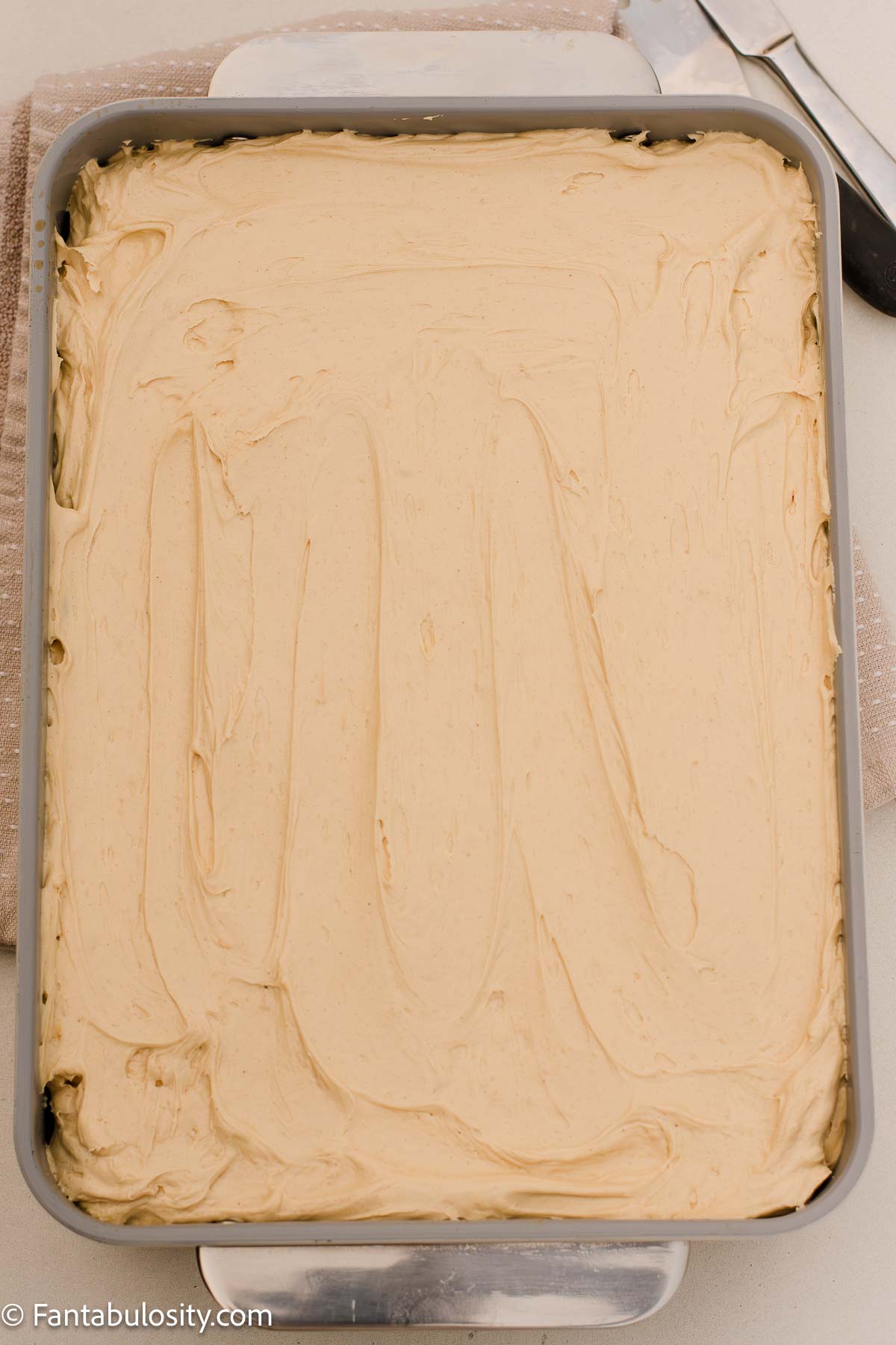 Creamy peanut butter frosting on top of peanut butter cake.