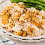Poppy Seed Chicken Casserole serving on a plate, next to green beans.
