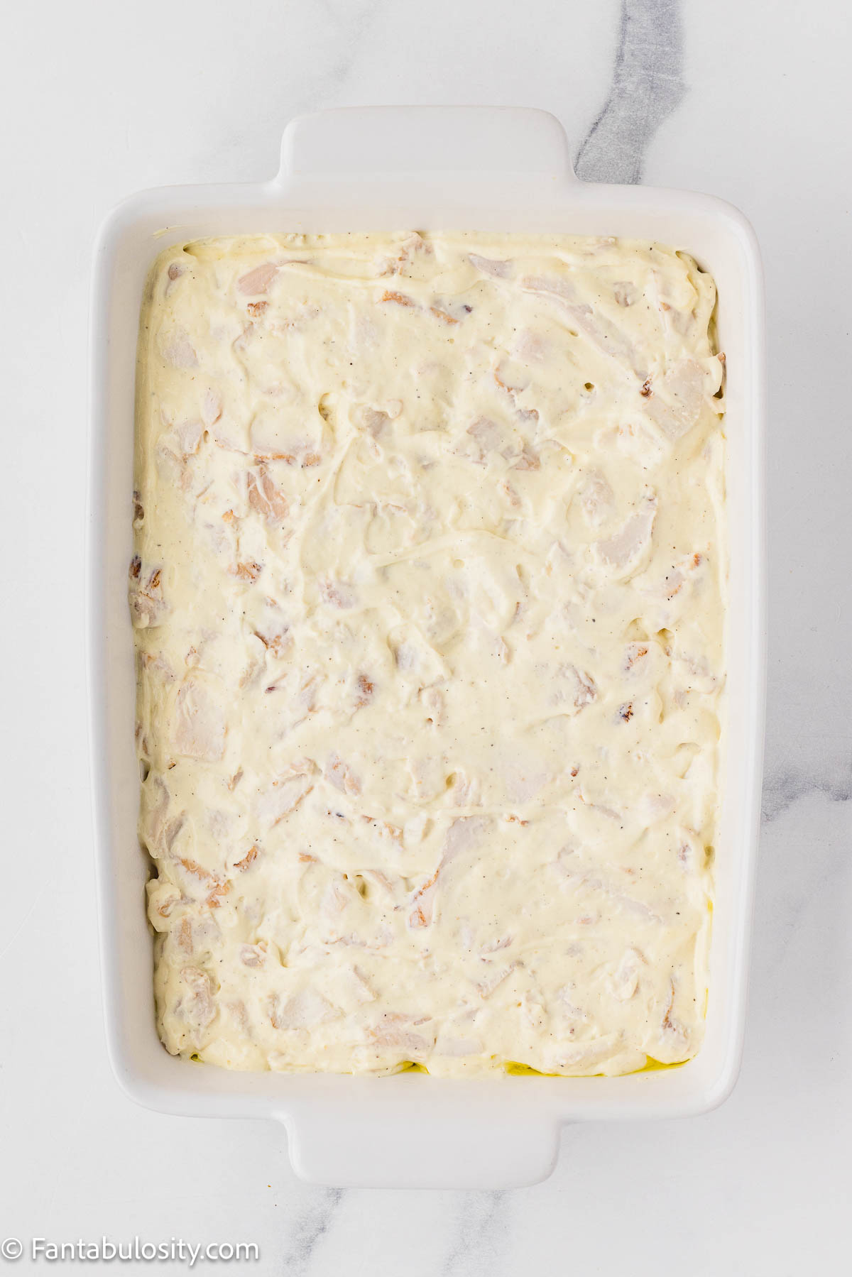 Chicken and soup mixture poured in to 9x13 baking dish.