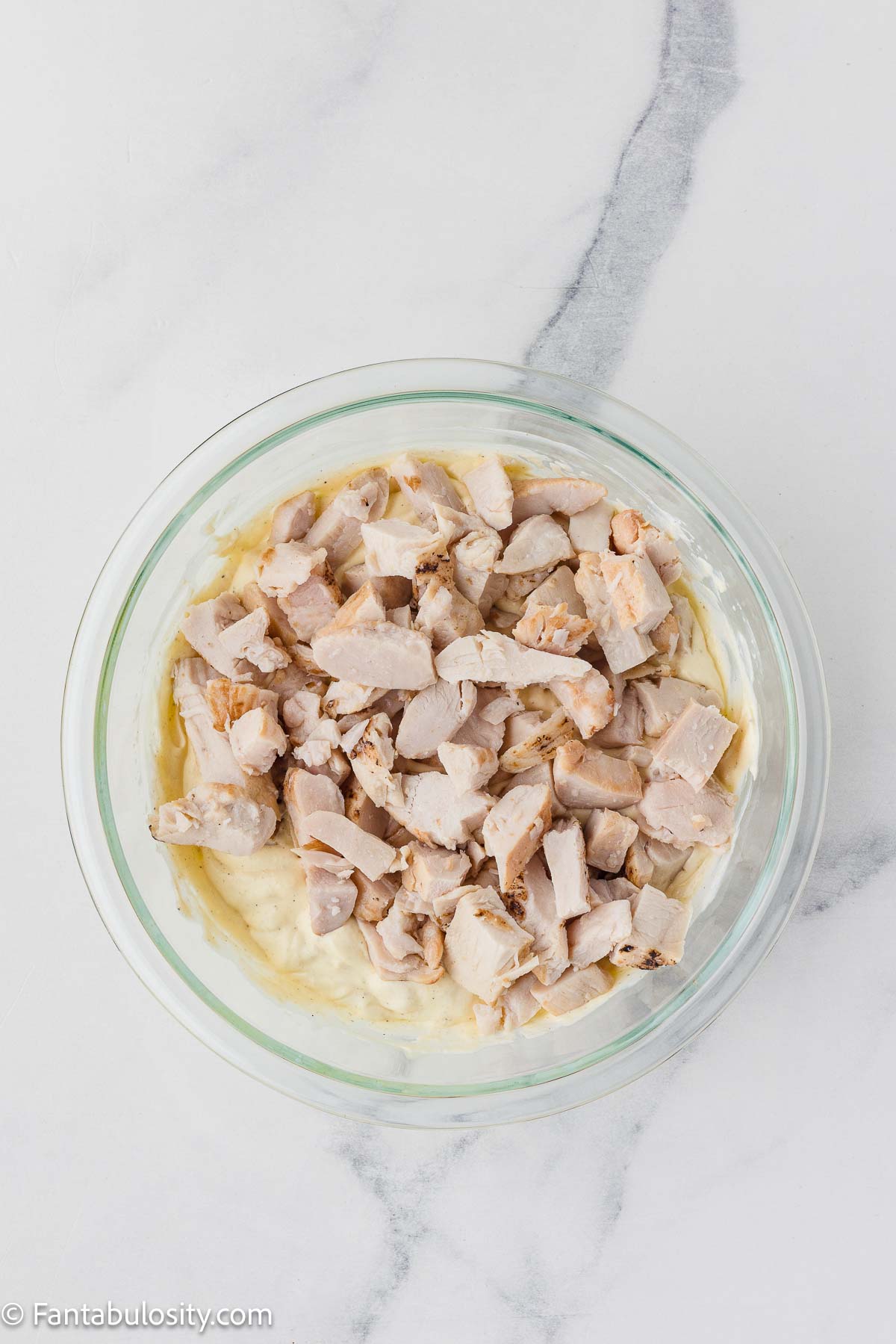 Chicken added to soup mixture in mixing bowl.
