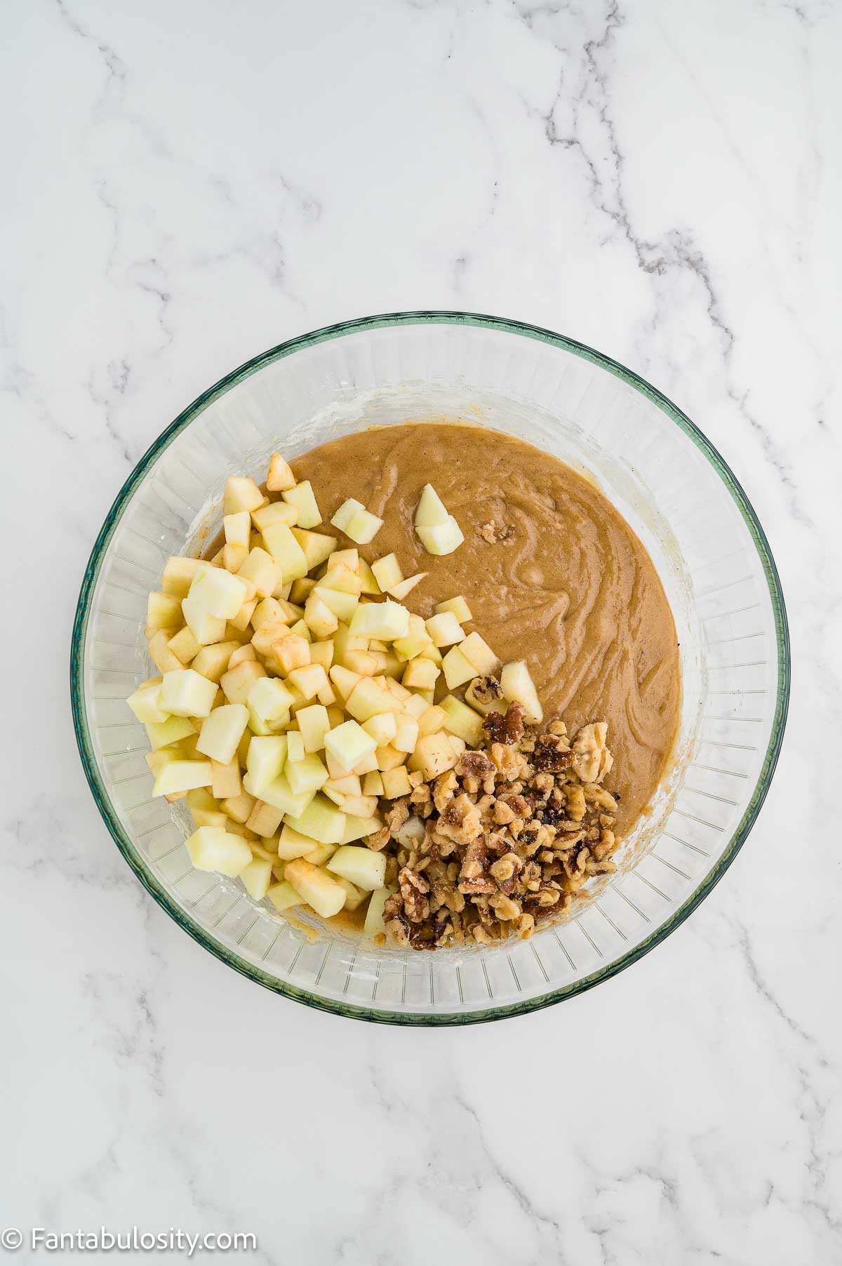 Chopped apples and walnuts folded into thick apple dapple cake batter.
