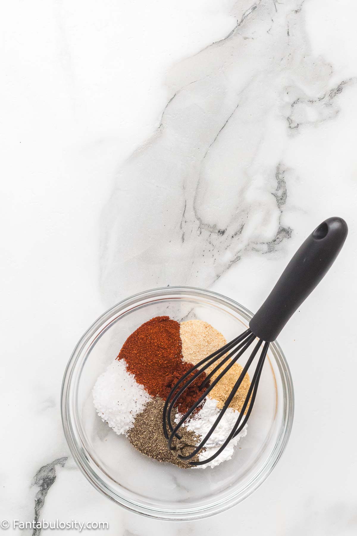 Salt, pepper, smoked paprika, garlic powder, onion powder, chili powder, and baking powder whisked together in a small bowl.